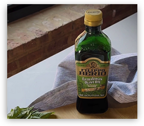 A bottle of olive oil on a cutting board.
