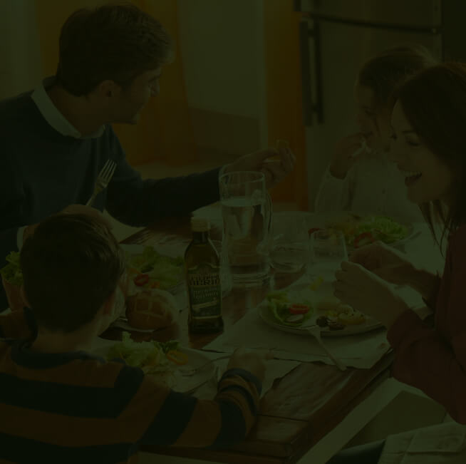 Family at a table eating dinner and chatting